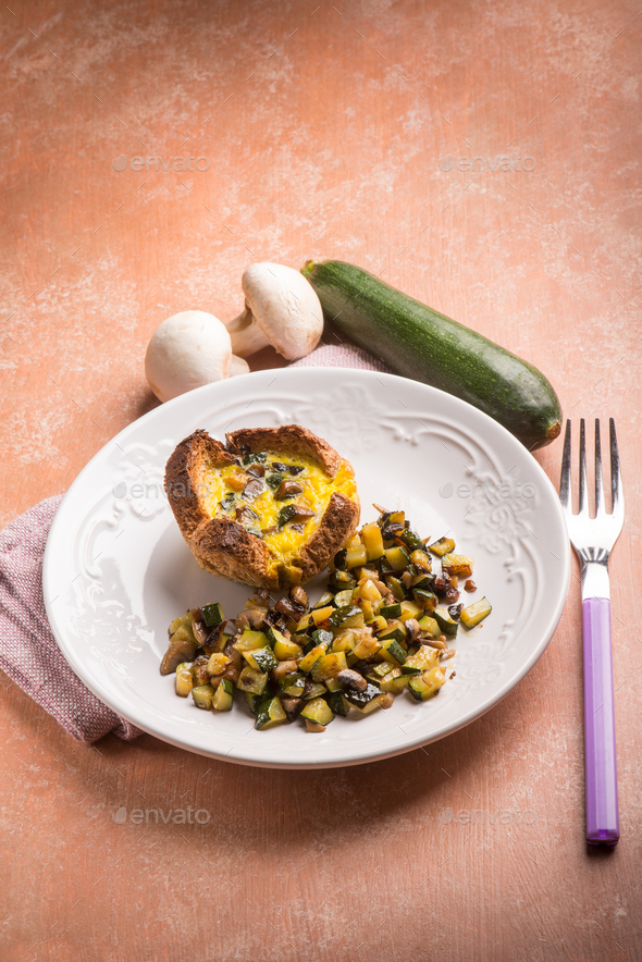 little cake with eggs mushroom and zucchinis Stock Photo by